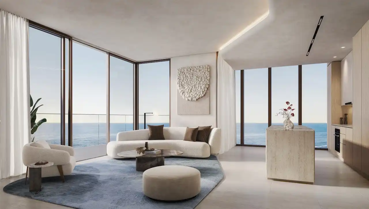 Luxury living room in a one bedroom apartment at Soulever with panoramic Gulf views, floor to ceiling windows, soft contemporary furnishings, and refined waterfront living in Dubai. Presented by Tohid Fetrat.