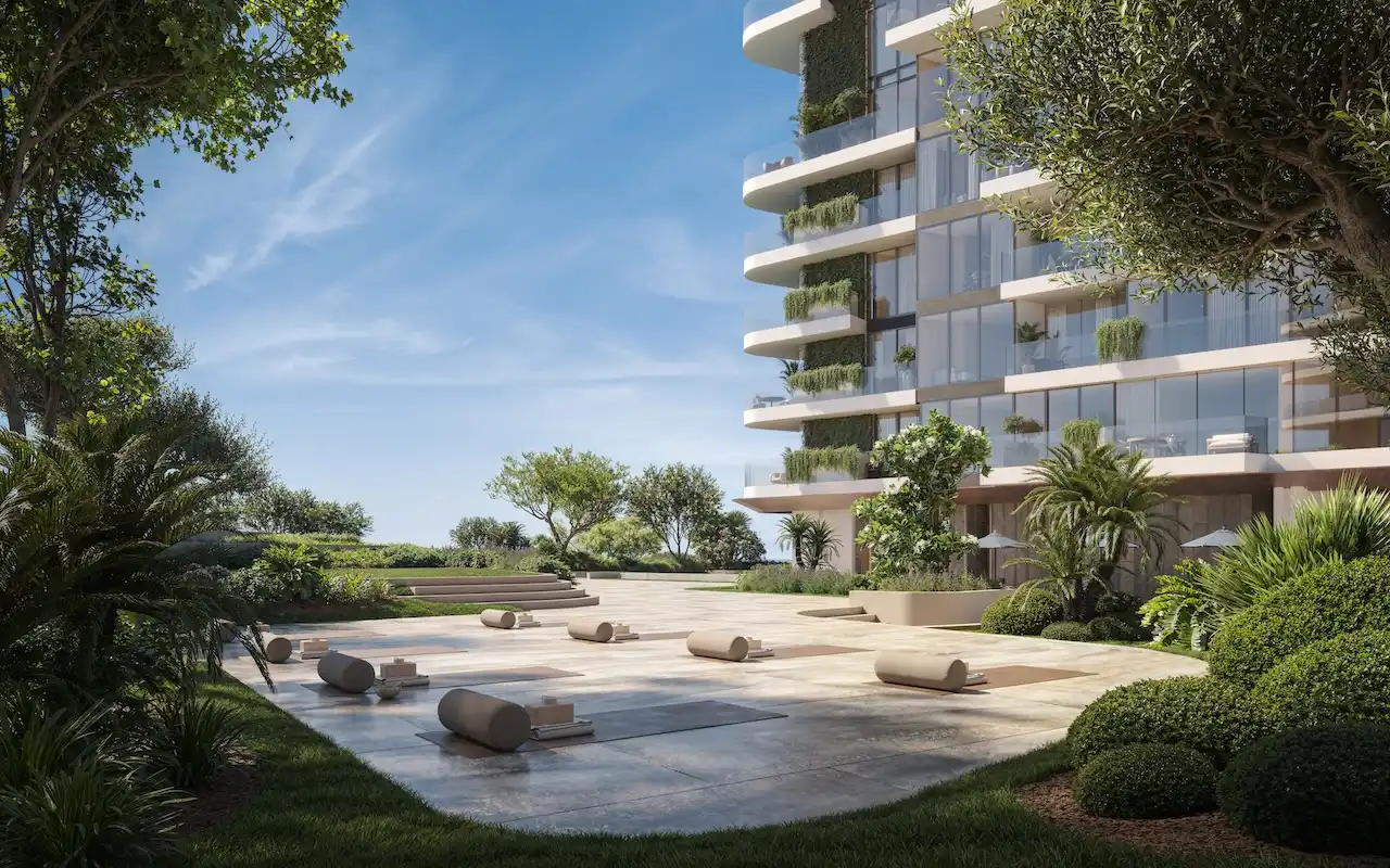 Outdoor yoga area at Soulever featuring a landscaped garden setting, tranquil open-air platform, and lush greenery beside the luxury residential building in Dubai with Gulf-inspired design. Presented by Tohid Fetrat.