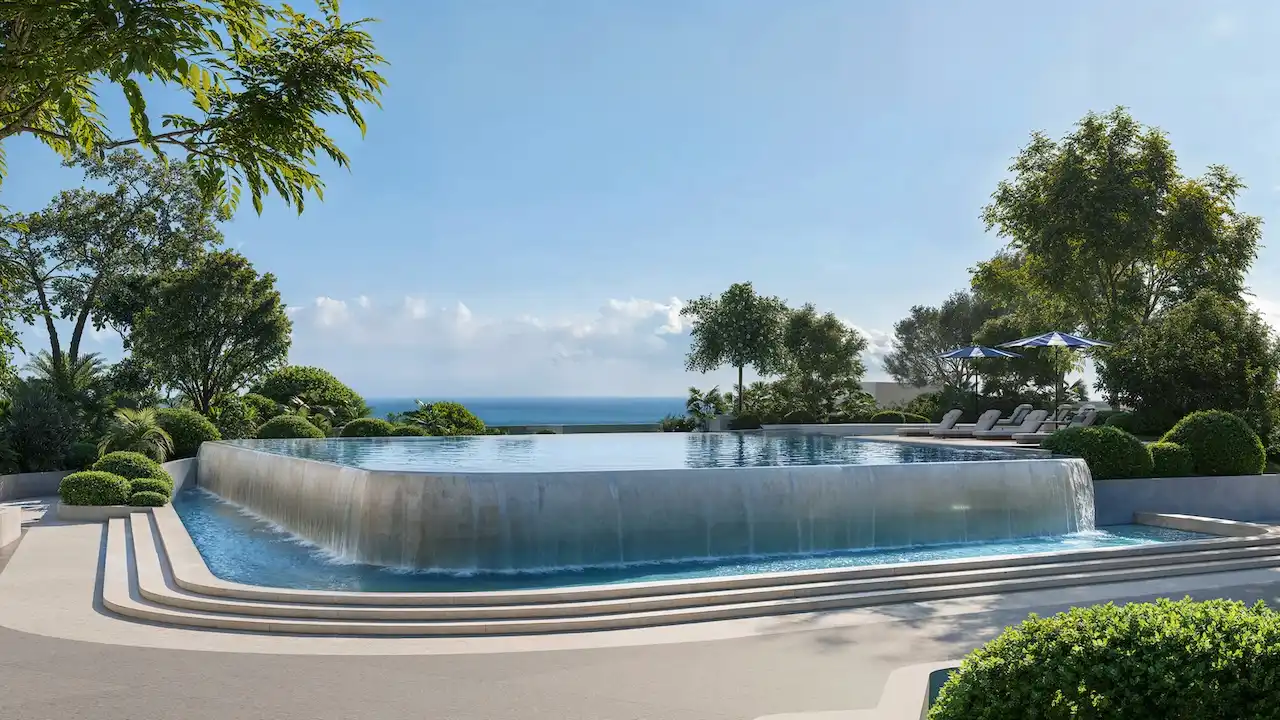 Overflow infinity pool at Soulever surrounded by landscaped gardens, offering serene seafront views of the Gulf in Dubai. Presented by Tohid Fetrat.