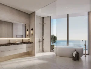 Penthouse master bathroom at Soulever with panoramic Gulf views, freestanding bathtub, floor to ceiling glass, natural stone finishes, and spa inspired luxury design in Dubai. Presented by Tohid Fetrat.