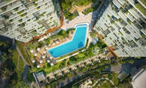 Aerial view of the Soulever podium featuring a central infinity pool, sun decks, and lush landscaped community spaces between luxury residential towers in Dubai with Gulf-inspired design. Presented by Tohid Fetrat.