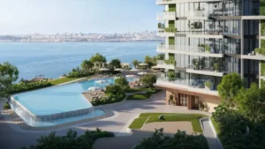 Podium view of Soulever featuring a seafront infinity pool, sun loungers, and landscaped terraces beside luxury residential towers overlooking the Gulf in Dubai. Presented by Tohid Fetrat.