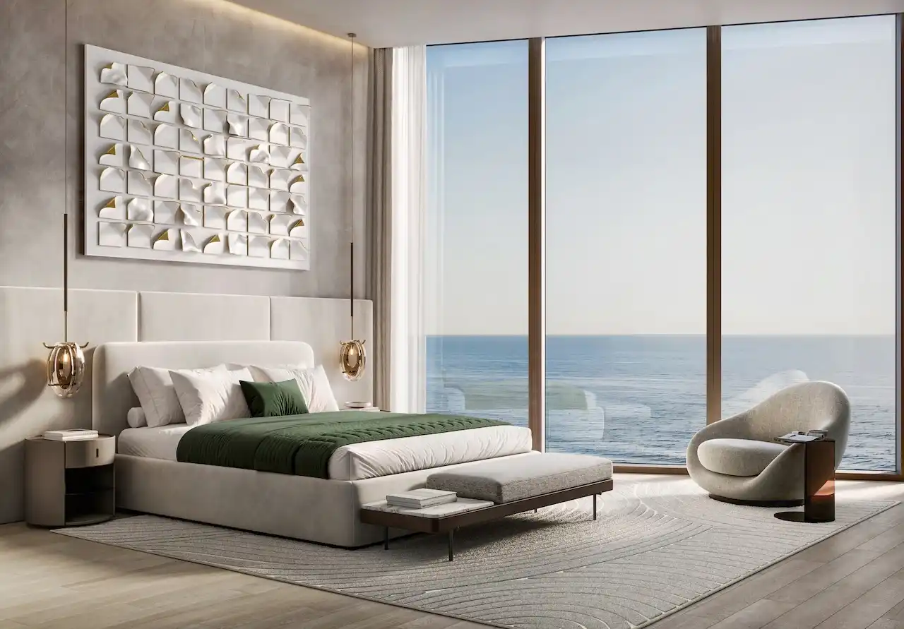 Luxury bedroom in a three bedroom apartment at Soulever featuring floor to ceiling windows, direct sea view, refined modern design, soft neutral tones, and elegant furnishings in Dubai. Presented by Tohid Fetrat.