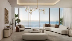 Luxury living room in a three bedroom apartment at Soulever featuring floor to ceiling windows, panoramic sea views, refined contemporary furniture, and a calm modern design in Dubai. Presented by Tohid Fetrat.