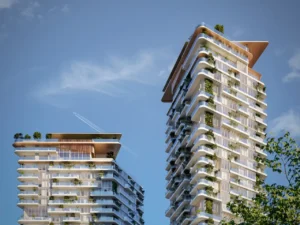 Daytime facade view of Soulever twin residential towers featuring layered balconies, integrated greenery, and contemporary waterfront architecture overlooking the Gulf in Dubai. Presented by Tohid Fetrat.