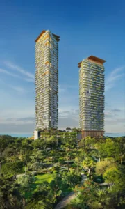 Daytime forest view of Soulever twin residential towers rising above lush landscaped gardens, featuring layered balconies, integrated greenery, and panoramic Gulf views in Dubai. Presented by Tohid Fetrat.