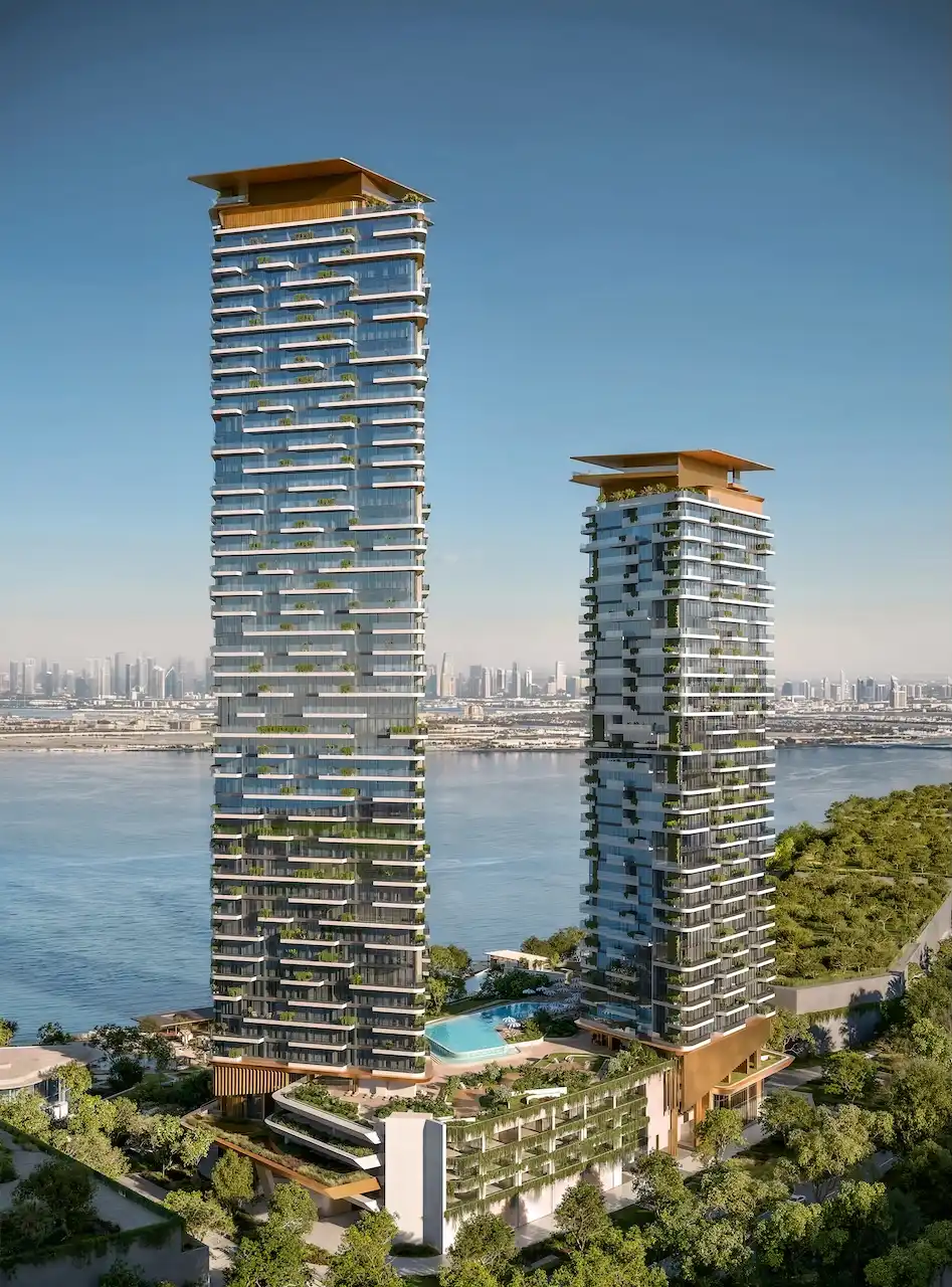 Rear daytime view of Soulever twin residential towers overlooking the Gulf, featuring cascading terraces, vertical greenery, and a landscaped podium with luxury amenities in Dubai. Presented by Tohid Fetrat.