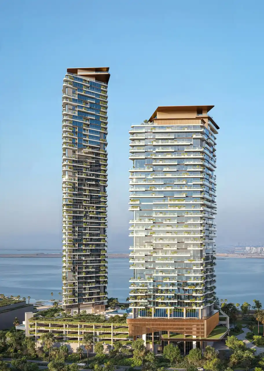 Daytime view of Soulever twin residential towers rising above landscaped podiums with direct Gulf frontage, showcasing contemporary waterfront architecture and ultra luxury living in Dubai. Presented by Tohid Fetrat.