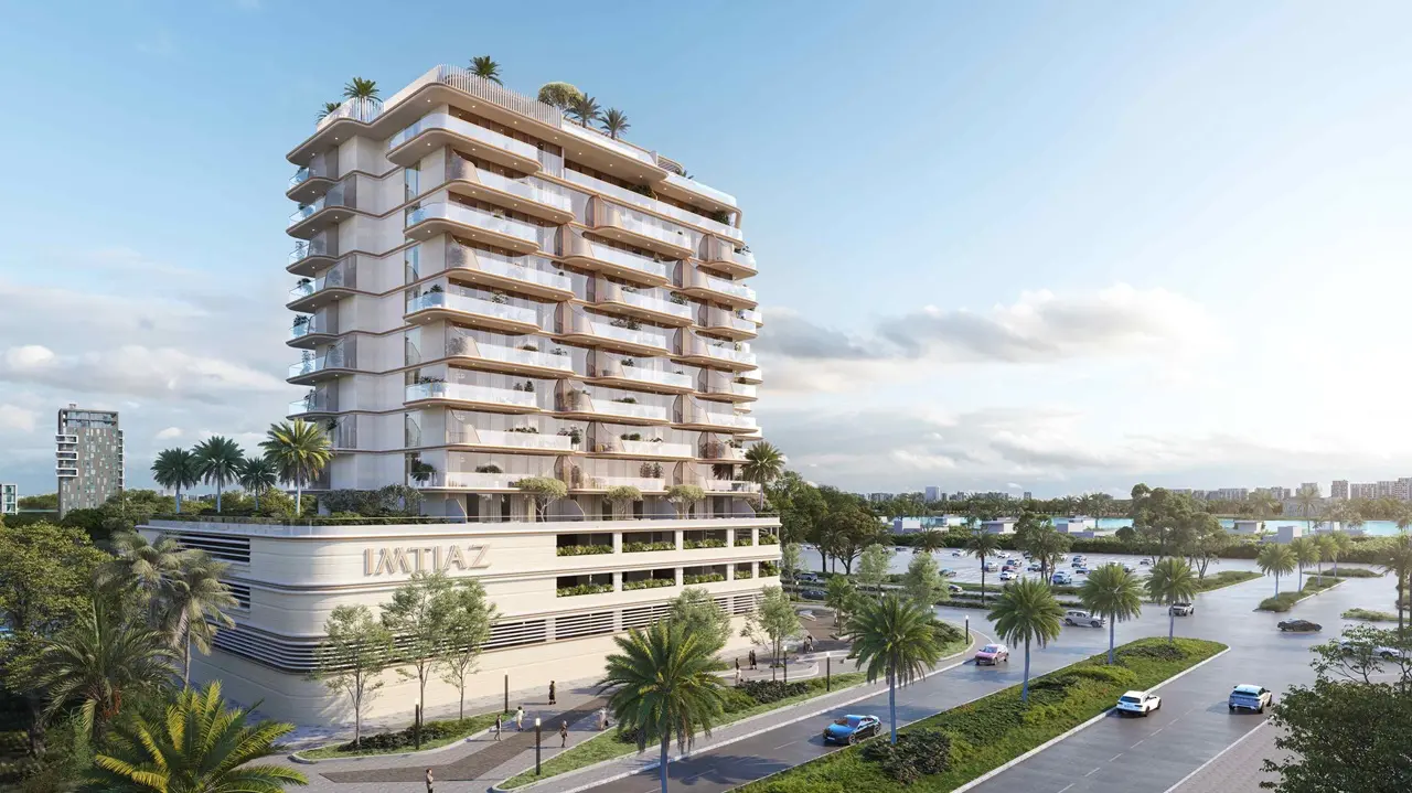 Exterior view of Sunset Bay Grand by Imtiaz showcasing a mid-rise luxury residential building with curved balconies, soft-toned façade, and palm-lined surroundings in Dubai, Presented by Tohid Fetrat