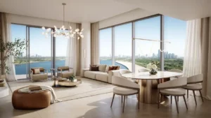 Elegant two-bedroom living and dining interior at The Edit at d3 with panoramic floor-to-ceiling windows, soft contemporary finishes, and waterfront skyline views in Dubai Design District, Presented by Tohid Fetrat