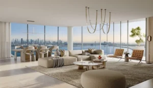 Luxury three-bedroom living and dining interior at The Edit at d3 with panoramic floor-to-ceiling windows, contemporary open-plan layout, refined neutral finishes, and Dubai skyline and waterfront views in Dubai Design District, Presented by Tohid Fetrat