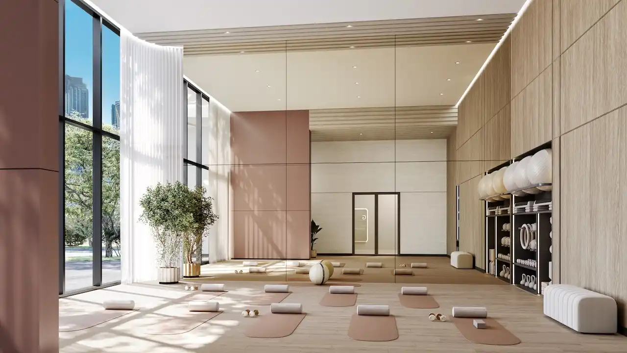 Calm yoga and wellness studio with natural light, floor-to-ceiling windows, mirrors, and yoga mats at The Edit at d3 in Dubai Design District, Presented by Tohid Fetrat
