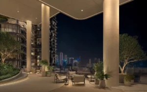 Night-time exterior lounge terrace with modern seating, landscaped planters, and illuminated architecture overlooking Dubai skyline at The Edit at d3 in Dubai Design District, Presented by Tohid Fetrat
