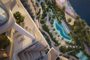 Aerial view of The Edit at d3 landscaped podium with curving swimming pool and waterfront promenade in Dubai Design District, Presented by Tohid Fetrat