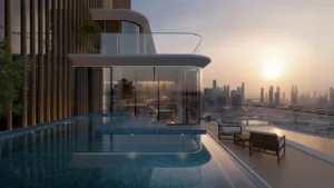 Penthouse private infinity pool terrace at The Edit at d3 with curved glass façade, sunset skyline views over Dubai Design District, and exclusive outdoor lounge, Presented by Tohid Fetrat