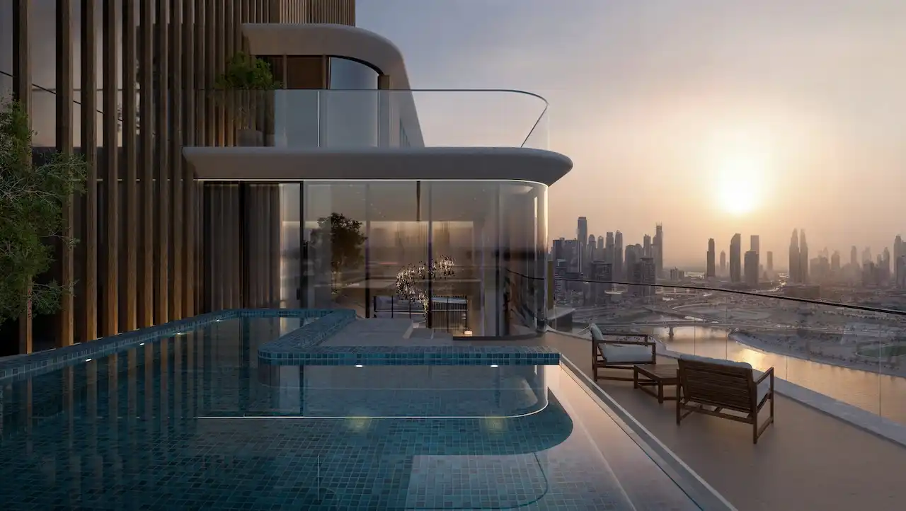 Penthouse private infinity pool terrace at The Edit at d3 with curved glass façade, sunset skyline views over Dubai Design District, and exclusive outdoor lounge, Presented by Tohid Fetrat