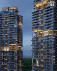Evening view of The Edit at d3 residential towers showcasing modern glass façades and illuminated terraces in Dubai Design District, Presented by Tohid Fetrat
