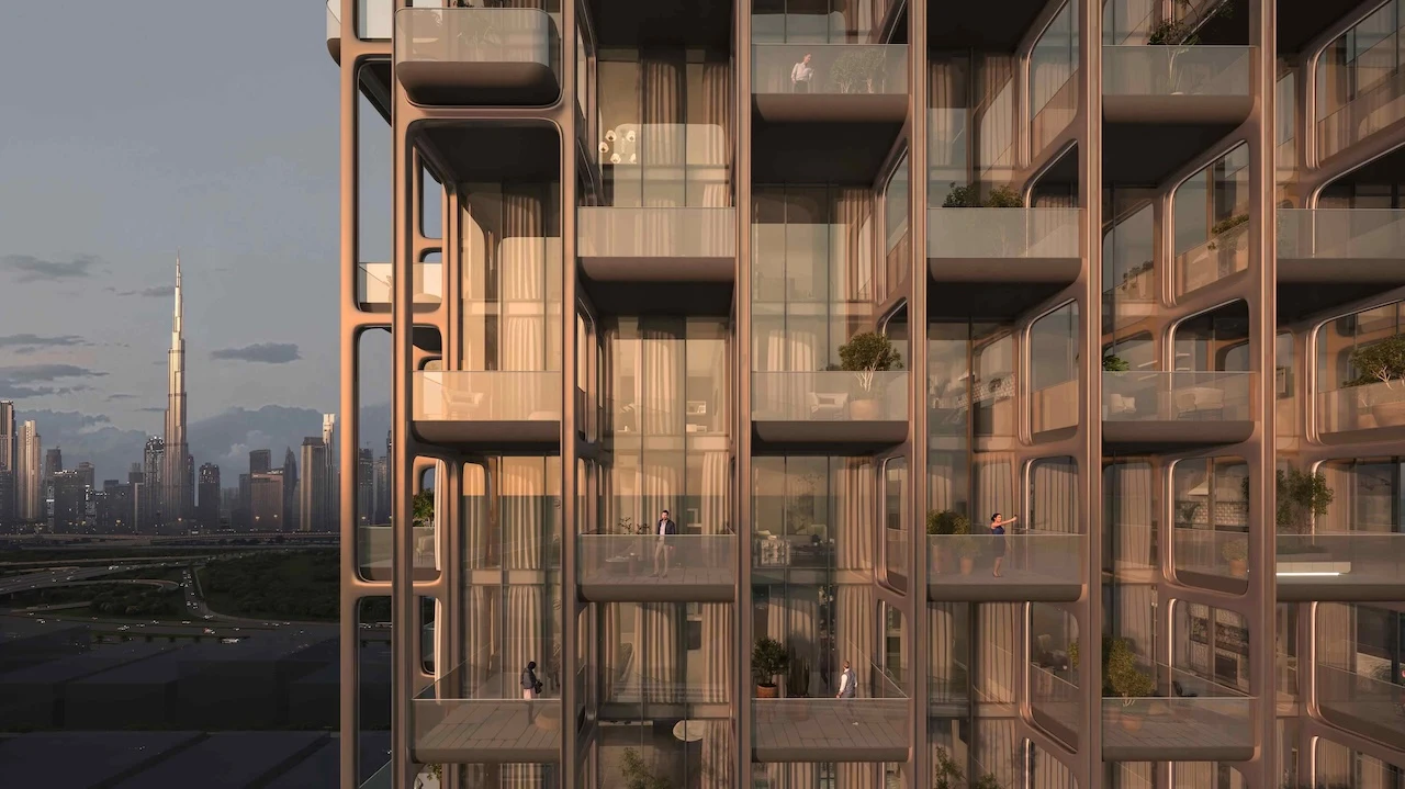 Contemporary exterior architecture of The Symphony Tower by Imtiaz showcasing sculptural balconies, bronze-toned façade, floor-to-ceiling glass, and panoramic Dubai skyline views including Burj Khalifa, Presented by Tohid Fetrat