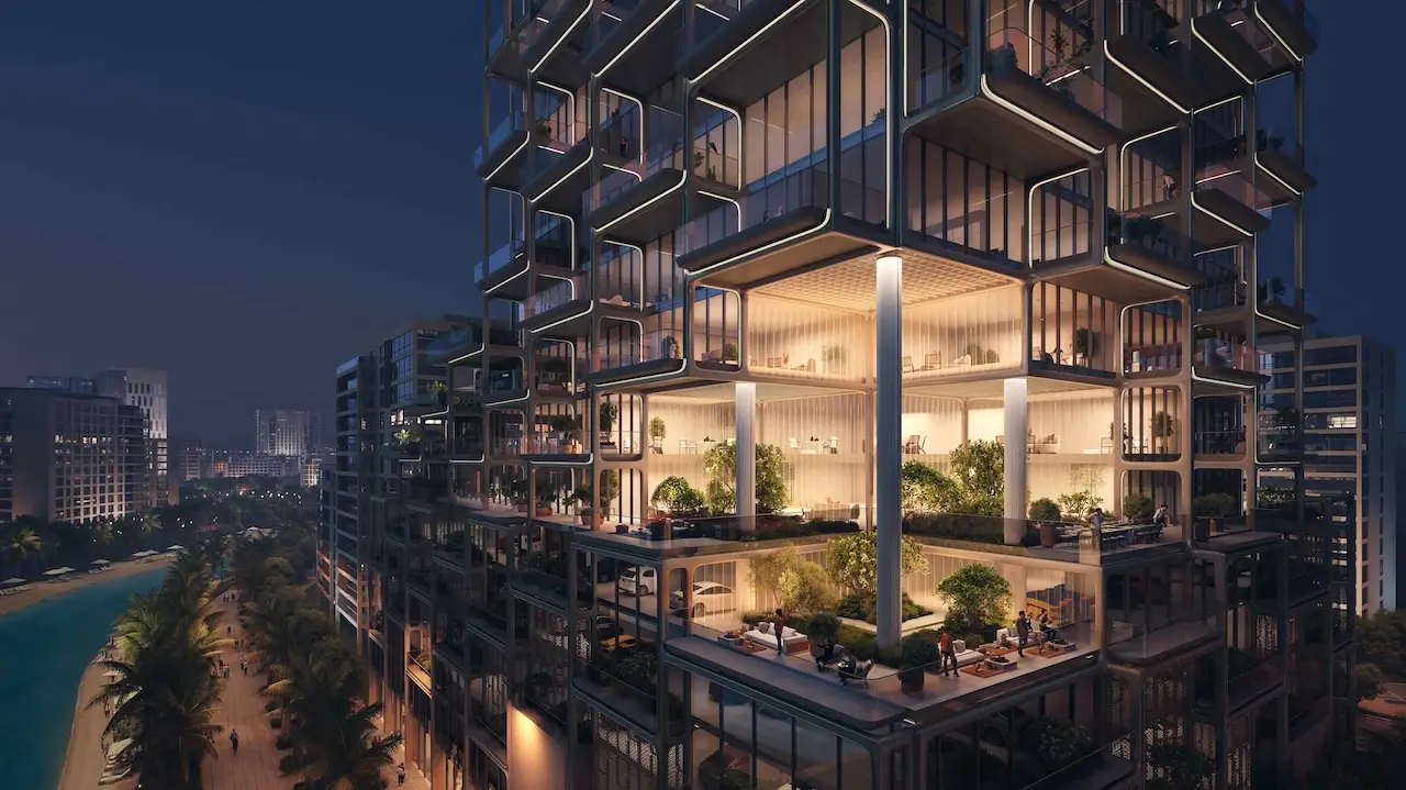 Nighttime exterior view of The Symphony Tower by Imtiaz featuring illuminated multi-level terraces, sculptural balcony architecture, lush sky gardens, and a contemporary Dubai urban setting, Presented by Tohid Fetrat