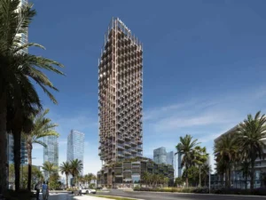 Daytime exterior view of The Symphony Tower by Imtiaz featuring its slender high-rise form, geometric balcony grid, and refined façade design set along a palm-lined boulevard in Dubai, Presented by Tohid Fetrat