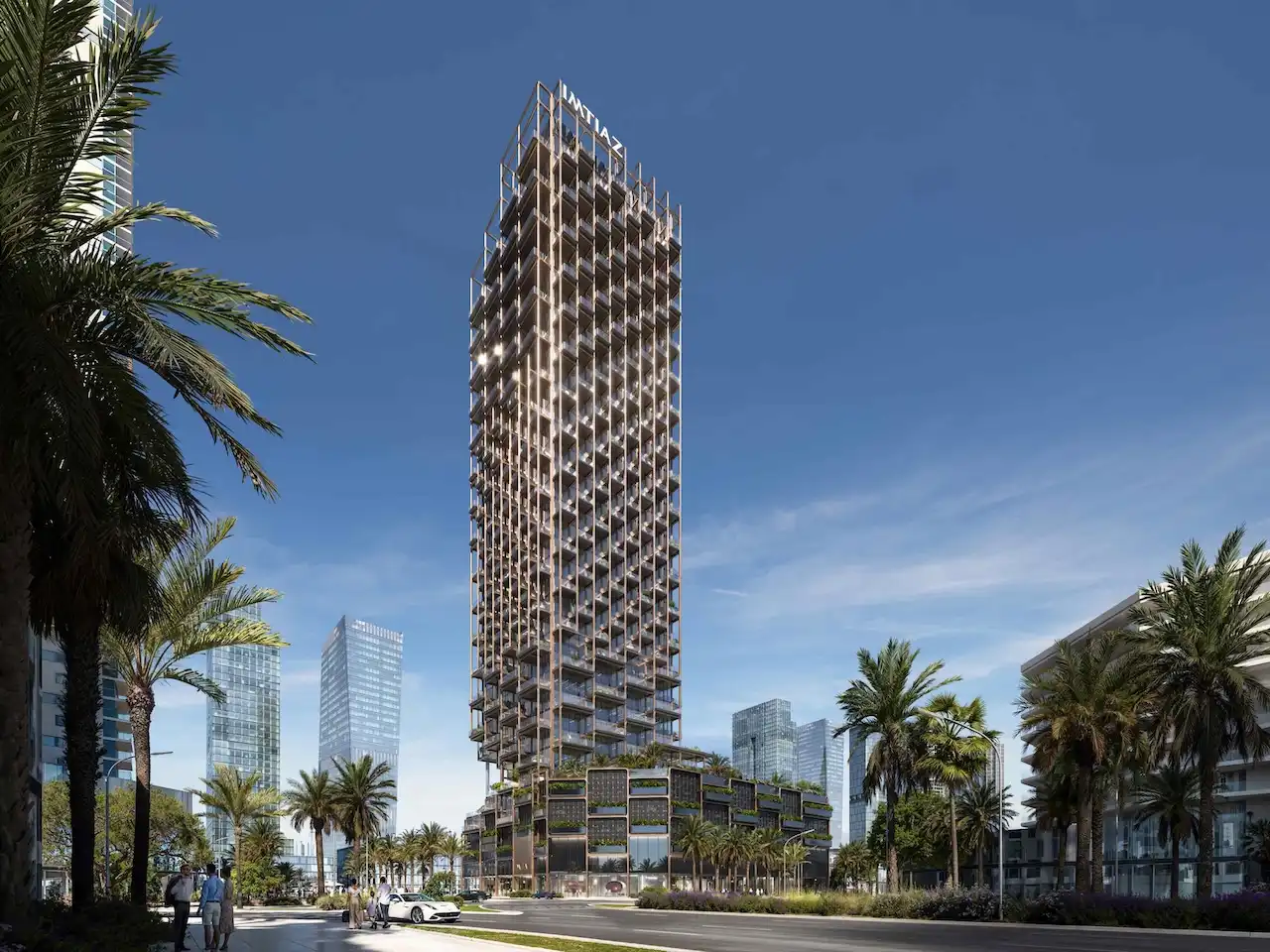 Daytime exterior view of The Symphony Tower by Imtiaz featuring its slender high-rise form, geometric balcony grid, and refined façade design set along a palm-lined boulevard in Dubai, Presented by Tohid Fetrat