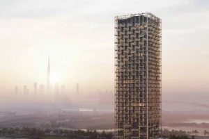 Full exterior view of The Symphony Tower by Imtiaz showcasing its sculptural high-rise architecture with illuminated balconies against the Dubai skyline and Burj Khalifa at sunset, Presented by Tohid Fetrat