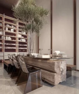 Luxury library and reading lounge interior at The Symphony Tower by Imtiaz featuring a sculptural wooden table, designer seating, integrated bookshelves, indoor tree, and refined contemporary design, Presented by Tohid Fetrat