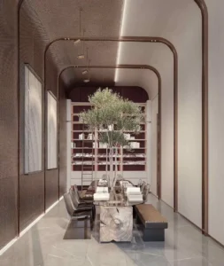 Luxury library and study room interior at The Symphony Tower by Imtiaz featuring a sculptural stone table, indoor tree centerpiece, designer seating, integrated bookshelves, and refined contemporary architecture, Presented by Tohid Fetrat