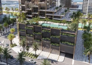 Podium-level swimming pool and landscaped terrace at The Symphony Tower by Imtiaz featuring palm-lined surroundings, sun loungers, and modern stepped architecture in Dubai, Presented by Tohid Fetrat