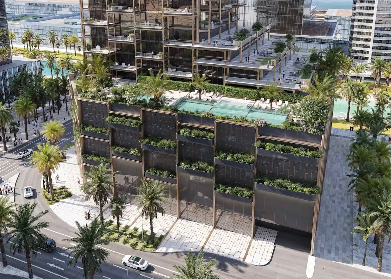 Podium-level swimming pool and landscaped terrace at The Symphony Tower by Imtiaz featuring palm-lined surroundings, sun loungers, and modern stepped architecture in Dubai, Presented by Tohid Fetrat