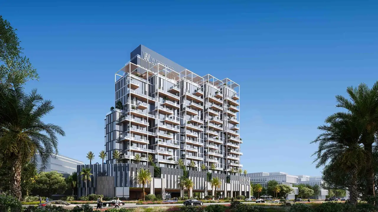 Exterior view of Wynwood by Imtiaz featuring a contemporary residential tower with layered balconies, modern façade design, and palm-lined surroundings in an urban Dubai setting, Presented by Tohid Fetrat