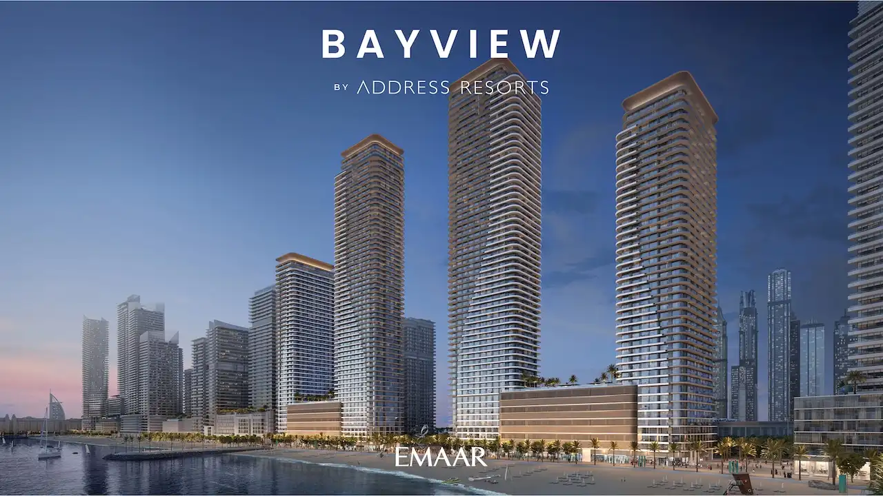 Waterfront exterior render of Bayview by Address Resorts at Emaar Beachfront, showcasing elegant high-rise towers, illuminated architectural lines, seaside promenade, and luxury beachfront living overlooking the Gulf, Presented by Tohid Fetrat