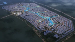 Maui at DAMAC Islands 2 evening aerial masterplan with illuminated lagoon waterways and villa community layout Dubai Presented by Tohid Fetrat