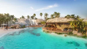 Mauritius at DAMAC Islands 2 lagoon waterfall leisure area with beach seating relaxation decks and waterfront community setting Dubai Presented by Tohid Fetrat