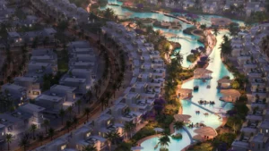 Aerial view of Tahiti at DAMAC Islands 2 lagoon community featuring waterfront villas landscaped islands leisure pavilions and illuminated evening pathways Presented by Tohid Fetrat