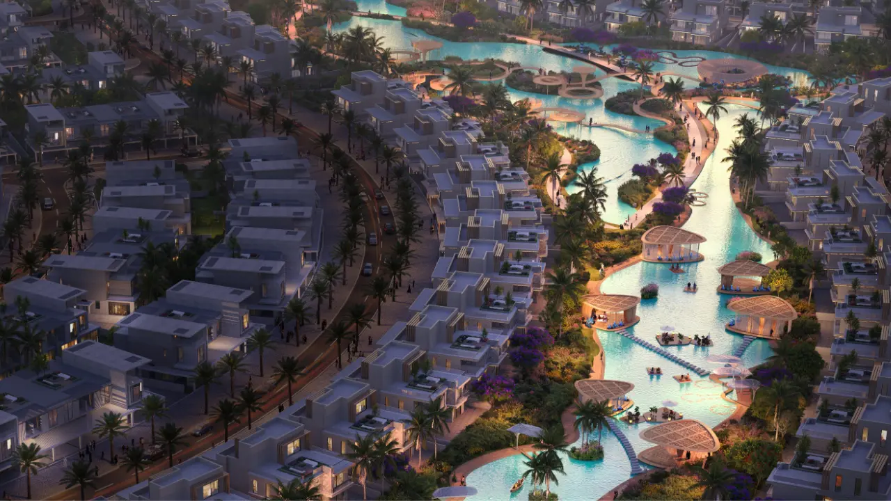 Aerial view of Tahiti at DAMAC Islands 2 lagoon community featuring waterfront villas landscaped islands leisure pavilions and illuminated evening pathways Presented by Tohid Fetrat