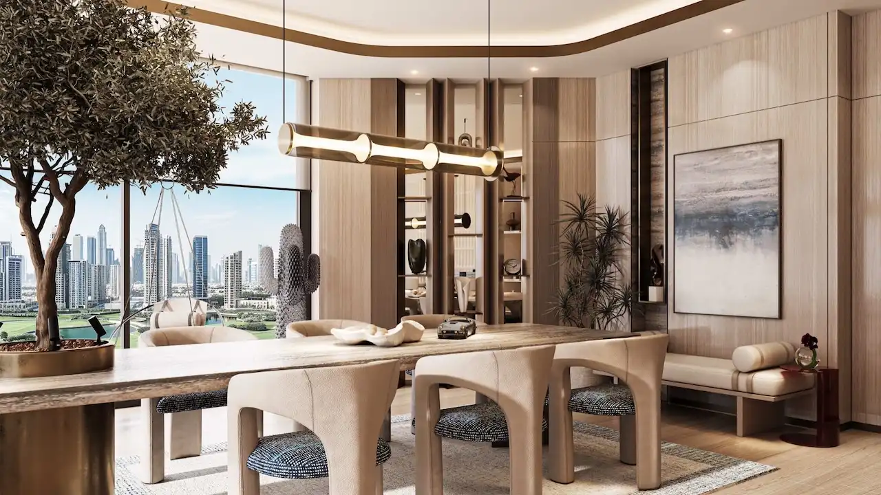 Luxury clubhouse dining and lounge interior at Inara Residence in Dubai featuring designer dining furniture, warm lighting, curated décor, and panoramic skyline views, presented by Tohid Fetrat