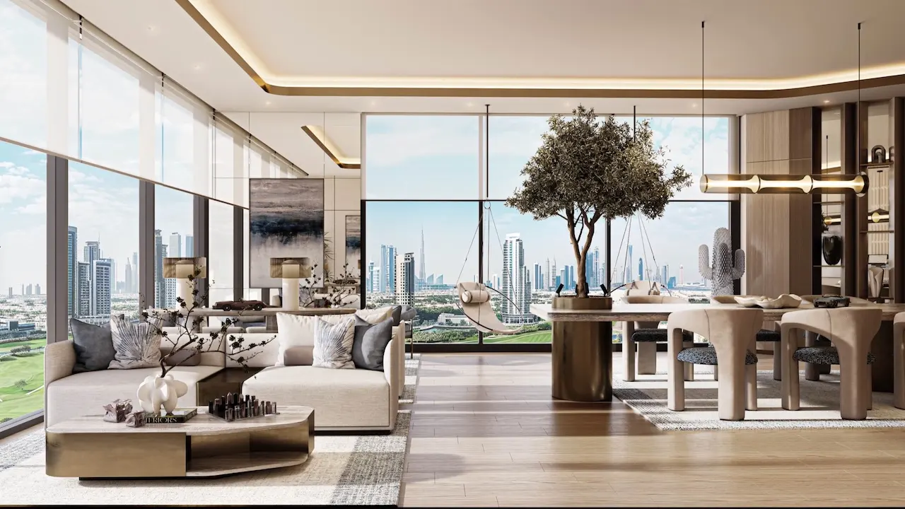 Panoramic clubhouse lounge and dining interior at Inara Residence in Dubai featuring open-plan layout, designer sofas, sculptural dining table, natural wood finishes, warm lighting, and full-height skyline views, presented by Tohid Fetrat