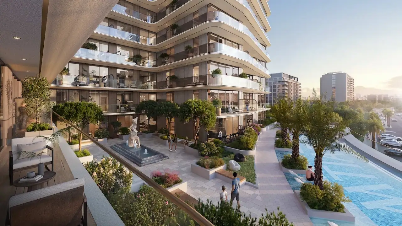 Daytime exterior courtyard view of Inara Residence in Dubai, featuring landscaped gardens, a central water feature, swimming pool, curved balconies, and modern residential architecture in a serene urban setting, presented by Tohid Fetrat