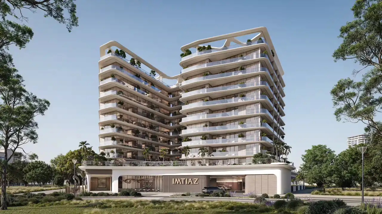 Night exterior view of Inara Residence in Dubai, showcasing illuminated contemporary architecture, warm façade lighting, layered balconies, and a refined residential presence within the urban skyline, presented by Tohid Fetrat