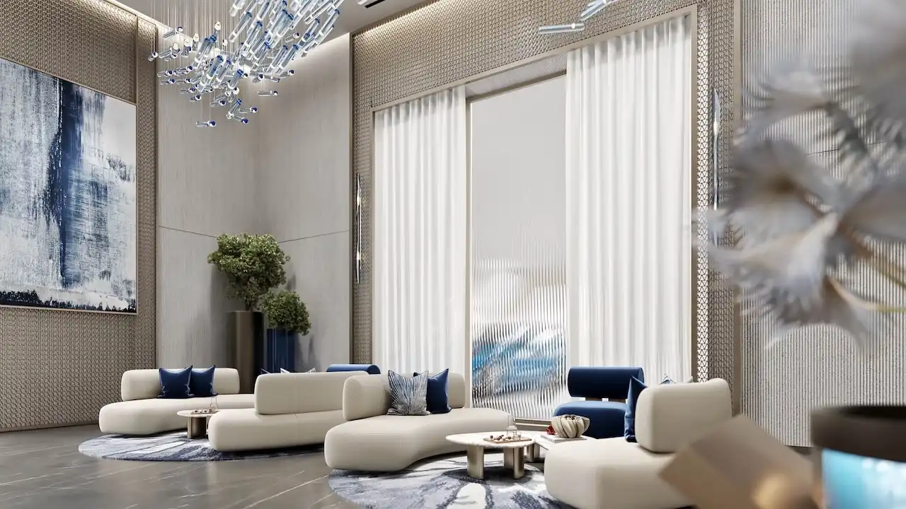 Elegant lobby seating area at Inara Residence in Dubai featuring sculptural lounge sofas, artistic chandelier lighting, refined wall textures, and a calm contemporary reception atmosphere, presented by Tohid Fetrat