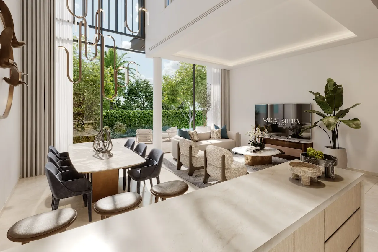 Dining area interior of a three bedroom townhouse at Nad Al Sheba Gardens Phase 11 with modern table setting, open plan layout and garden view Presented by Tohid Fetrat