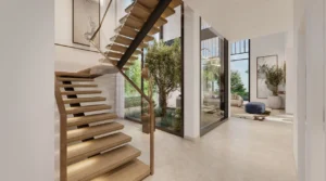 Interior staircase and corridor of a four bedroom villa at Nad Al Sheba Gardens Phase 11 with modern wooden steps, glass railing and natural daylight Presented by Tohid Fetrat