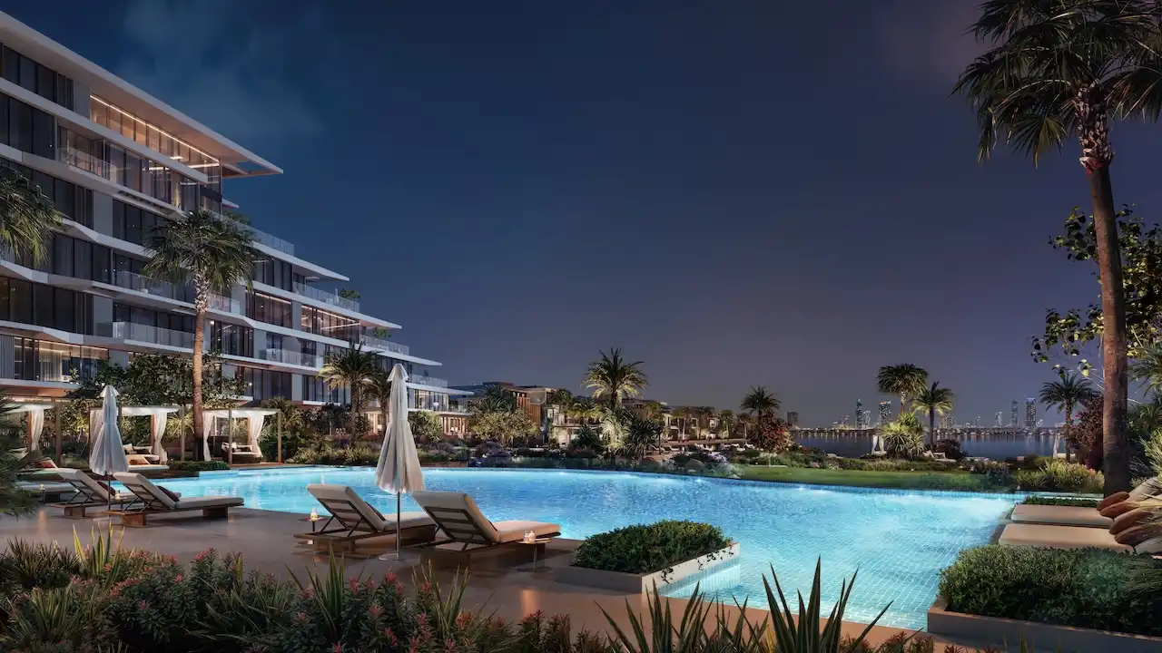 Palm Central Frond M Residences infinity pool night view overlooking waterfront lagoon at Palm Jebel Ali Dubai - Presented by Tohid Fetrat
