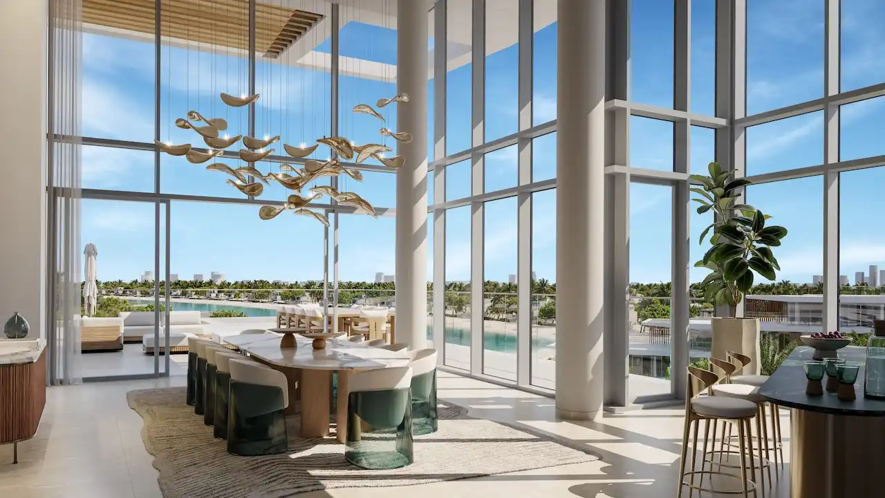 Palm Central Frond M Residences luxury dining area with double height windows and waterfront views at Palm Jebel Ali Dubai - Presented by Tohid Fetrat