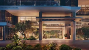 Palm Central Frond M Residences at Palm Jebel Ali illuminated residential entrance and modern façade at night Dubai - Presented by Tohid Fetrat