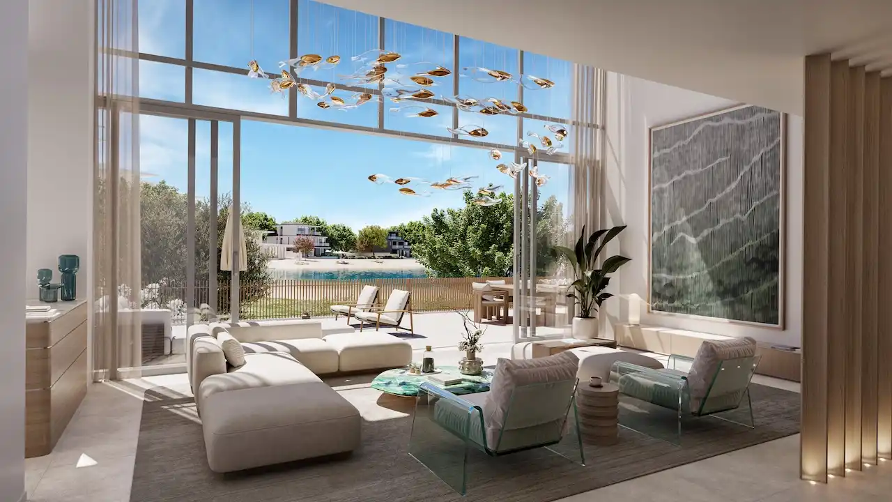 Luxury living room with floor to ceiling windows and waterfront garden views at Palm Central Frond M Residences in Palm Jebel Ali Dubai - Presented by Tohid Fetrat
