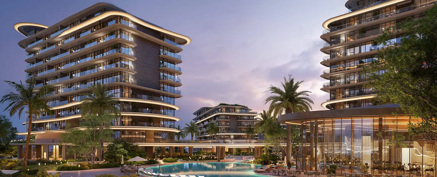Evening view of The Meriva Collection by Ellington with illuminated facades, resort pool and landscaped surroundings in Dubai Presented by Tohid Fetrat
