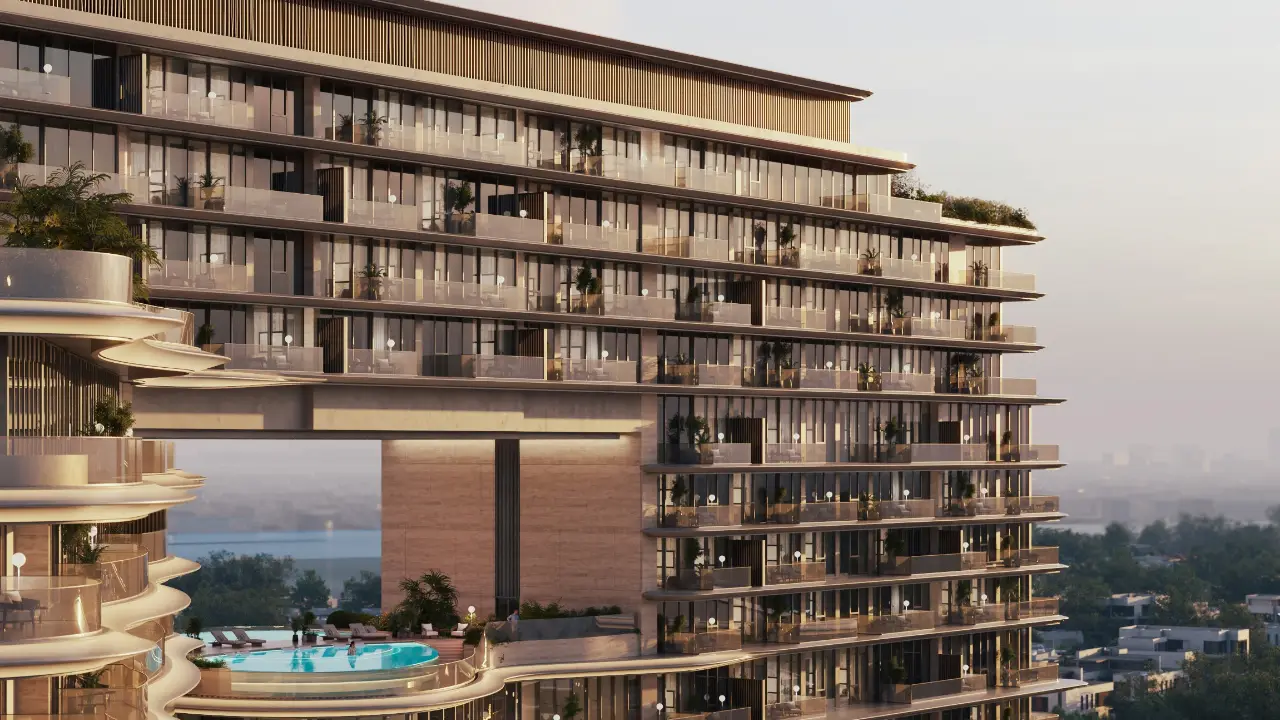 Facade detail of The Meriva Collection by Ellington displaying layered balconies, glass railings and elevated pool deck in Dubai Presented by Tohid Fetrat
