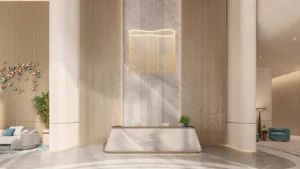 Reception area at The Meriva Collection by Ellington featuring marble desk, artistic lighting and luxury lobby design in Dubai Presented by Tohid Fetrat